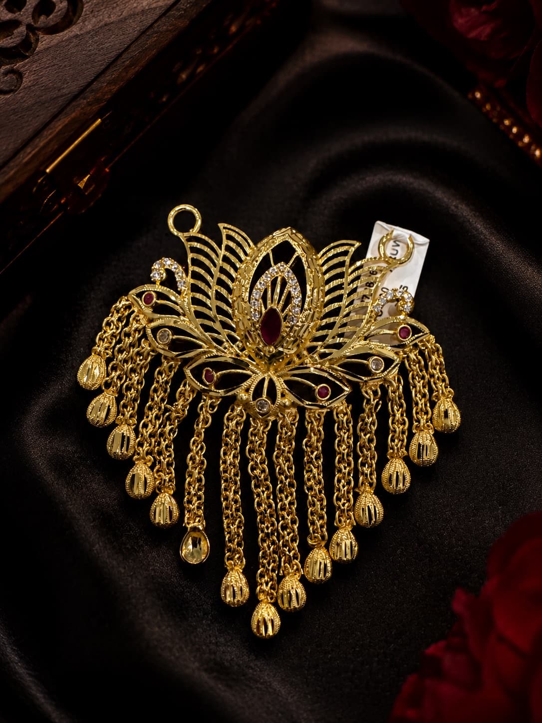 Otus Pendant Featuring A Ruby Gemstone And Dangling Chains.